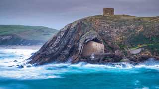 Rock outcropping building ocean tilt - a small building free wallpaper