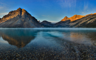 Mountain reflection lake shore sky - rock and pebbles free wallpaper