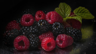 Raspberries blackberries leaves water droplets - a black surface free wallpaper