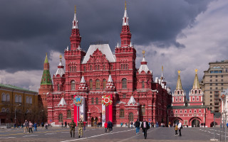 Red building clock tower cityscape - side and people free wallpaper