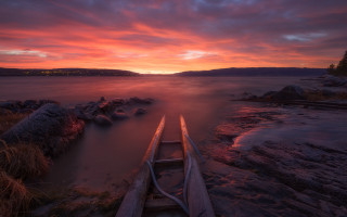 Canoe shore lake sunset clouds - a red sky in the background free wallpaper