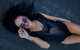 Tattooed woman sunglasses skyline fireworks - her arm behind her head free wallpaper for desktop