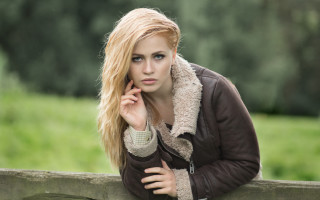 Woman leaning fence serious portrait - a fence free wallpaper