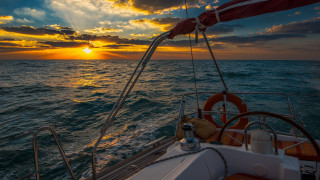 Sunset boat ocean clouds horizon - the sun setting behind free wallpaper