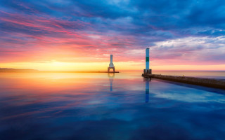 Sunset water tower clouds boat - a sunset over a body of water free wallpaper