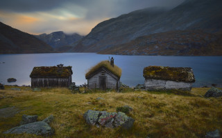 Small houses lake mountains sunset - top of a grass free wallpaper