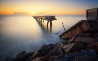 Pier rocky shore ocean sunset - a pier free wallpaper for desktop