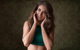 Woman green top posing face - a green top free wallpaper