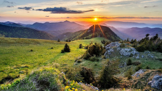 Sunset mountain range grassy field 2 - the foreground and mountains free wallpaper