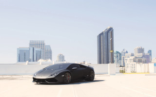 Black sports car city skyline - a black sports car free wallpaper