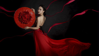 Woman red dress red fan - a black background behind her free wallpaper for desktop