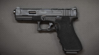 Black gun on table realistic - a black handle free wallpaper