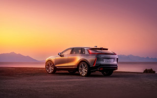 Car beach sunset ocean ufuturism - a sunset in the background and a body of water free wallpaper