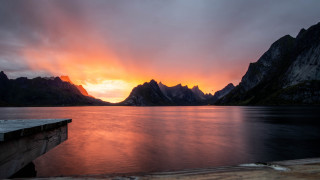Sunset mountain lake dock city - a sunset over a mountain range free wallpaper