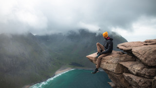 Man yellowhat cliff water mountains - a body of water and mountains free wallpaper