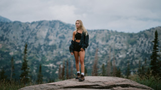 Mountain woman blonde glasses gloves - top of a rock free wallpaper