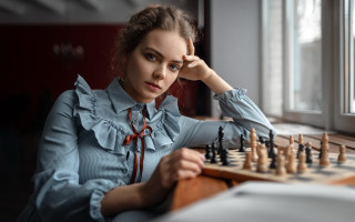 Woman chessboard table hand head - a woman sitting free wallpaper