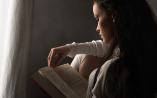 Woman reading chair window curtain - a white curtain behind her free wallpaper