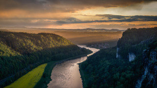 River forest sunset sky rays - a lush green forest under a cloudy sky free wallpaper