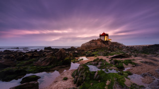 Lighthouse rocky shore purple sky 2 - a purple sky in the background free wallpaper