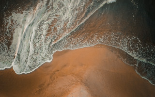 Beach waves sand brown water - a microscopic photo free wallpaper
