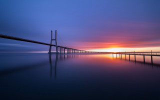 Sunset bridge water orange sky - a long bridge free wallpaper