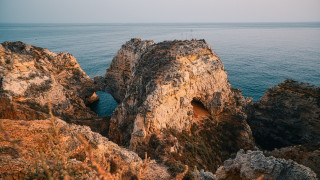 Rocky cliff hole ocean shore - a rocky cliff free wallpaper