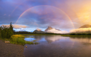Rainbow over lake mountains sky - a mountain in the distance free wallpaper