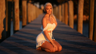 Woman white dress dock sitting - a wooden dock free wallpaper