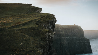 Cliff overlooking ocean lighthouse figure - denis eden free wallpaper