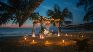 Beach canopy candles night romantic - a couple sitting free wallpaper