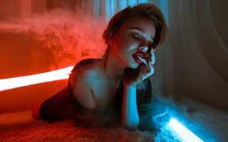 Woman laying laptop red blue - a blue light behind her free wallpaper