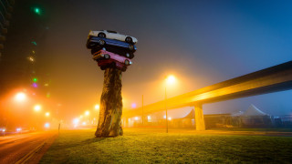 Car stacked on tree city - a surrealist sculpture free wallpaper