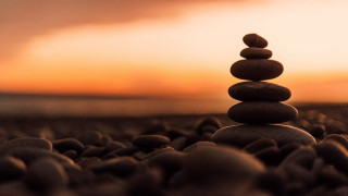 Stack rocks field sunset sky - symmetric free wallpaper