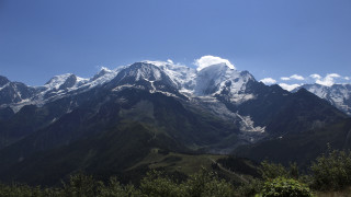 Mountain range clouds trees bushes - a few tree below free wallpaper