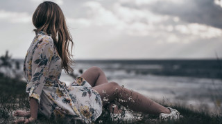 Woman sitting grass looking water - free bikini wallpaper