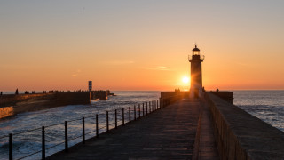 Lighthouse pier sunset ocean fence - the background and the ocean in the foreground free wallpaper