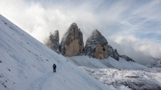 Hiking man snowy mountain clouds - a snowy mountain free wallpaper