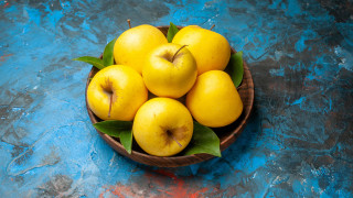 Yellow apples bowl blue surface - a bowl free wallpaper