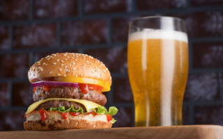 Hamburger beer wooden table brick - a brick wall in the background free wallpaper