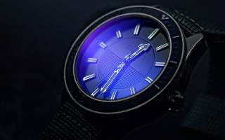 Blue watch retrofuturism gear clock - a blue light in the middle free wallpaper
