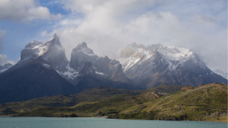 Mountain range snow water clouds - a body of water below free wallpaper