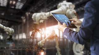 Factory robots man laptop blurry - free technology wallpaper for desktop