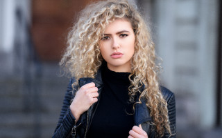 Curly haired woman black jacket - curly hair free wallpaper