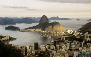 City mountain water boats scenery - a mountain in the background and a body of water free wallpaper