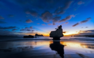 Beach sunset rock formation water - a rock formation free wallpaper