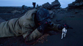 Person laying camera stormtrooper toy - photography free wallpaper