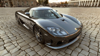 Black sports car cobblestone street 2 - a building in the background free wallpaper for desktop