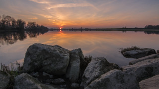 Sunset lake rocks grass mountain 2 - the foreground and a body of water free wallpaper