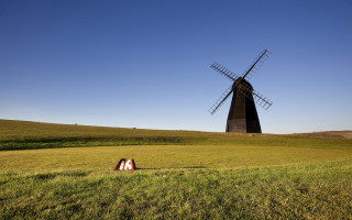 Windmill field person tiltshift sunset - a windmill in a field free wallpaper